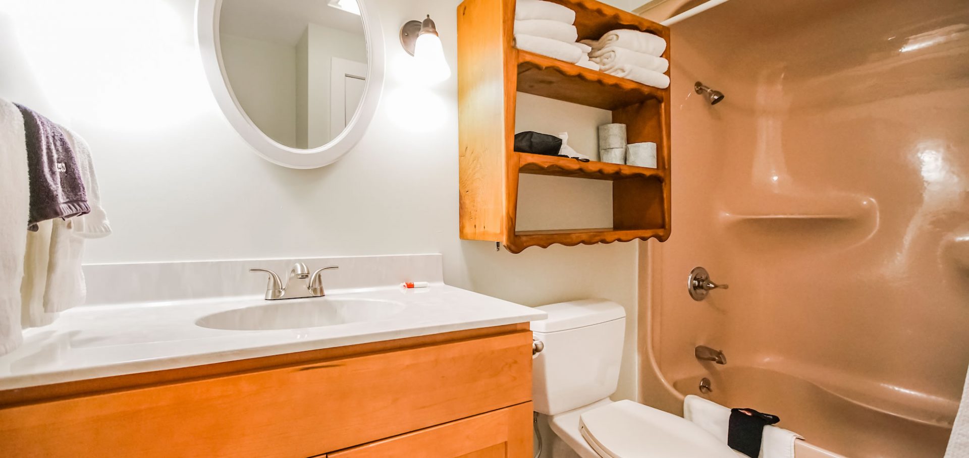Photo of bathroom showcasing sink, toilet, tub/shower